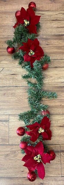 Christmas Garland with Poinsettia flowers and red christmas balls