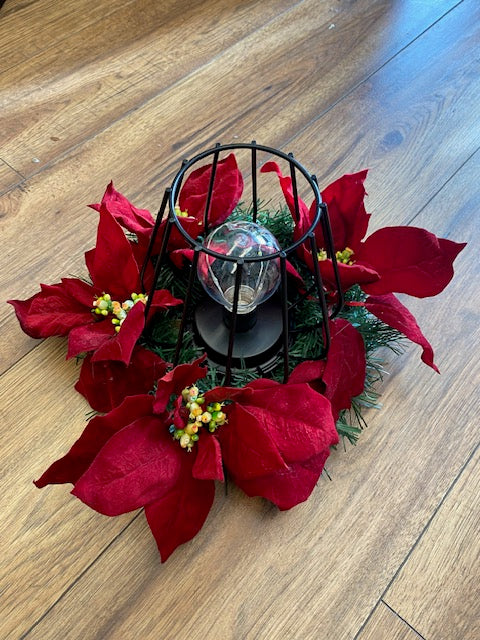 Christmas Wreath with poinsettia and metal black fairy light lamp